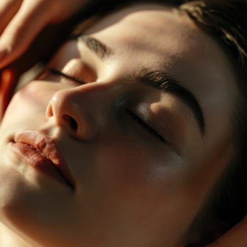 A woman is seen receiving a relaxing facial massage at a spa. This image can be used to depict the pampering and rejuvenating experience of a spa treatment.
