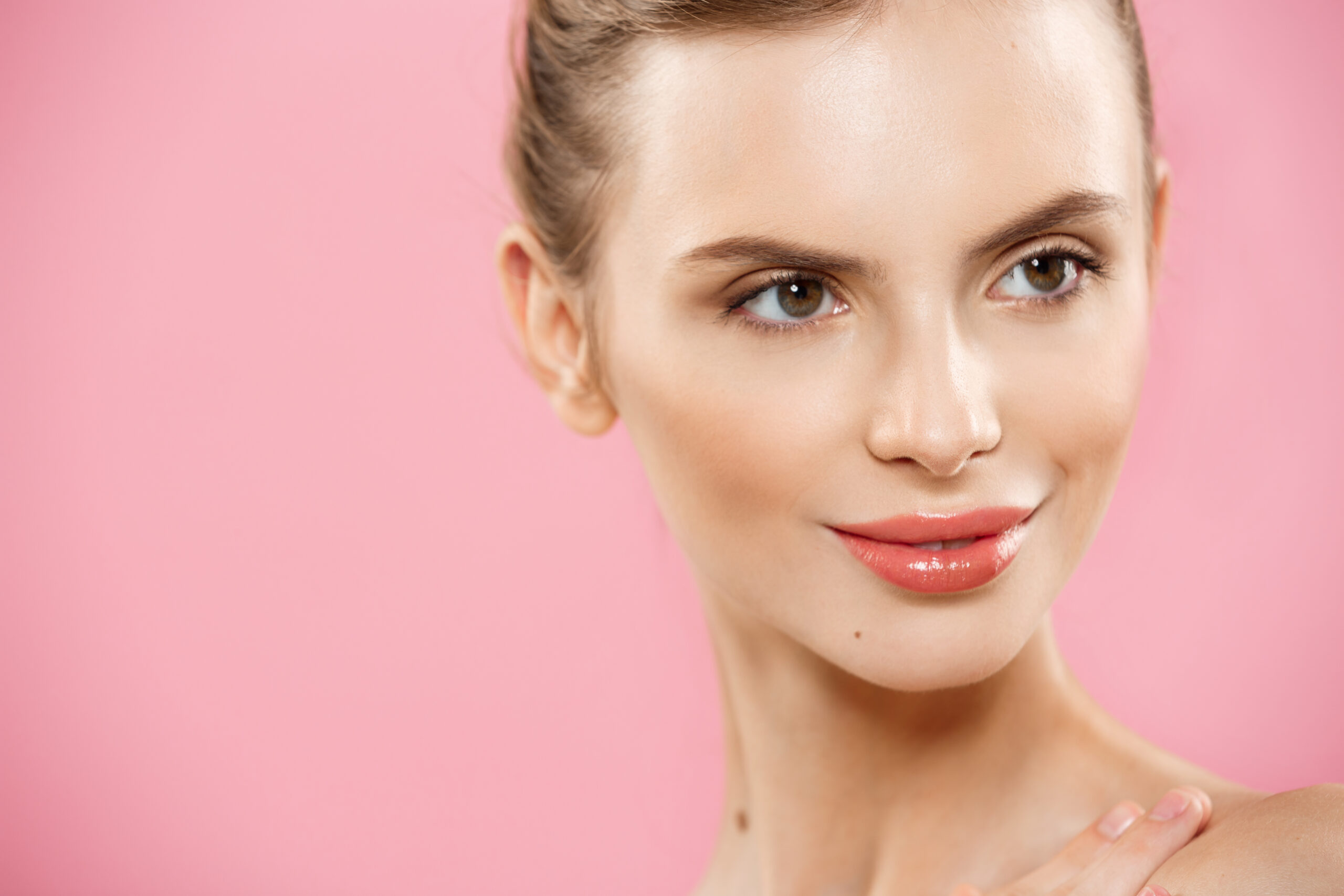 Skin Care Concept - Charming young caucasian woman with perfect makeup photo composition of brunette girl. Isolated on pink background with Copy Space.